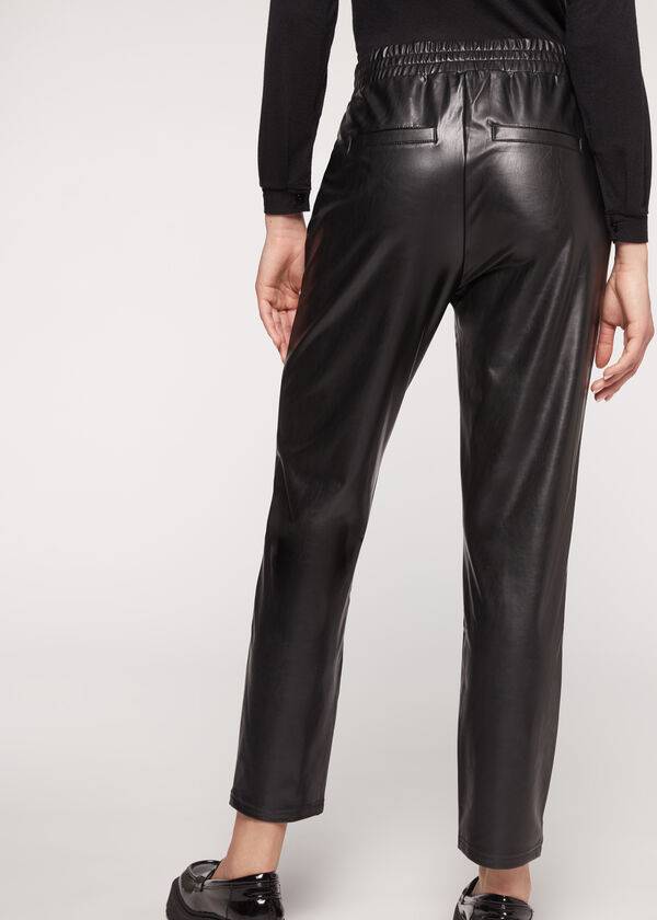 pantalones negros calzedonia con efecto térmico recubierto y ribete de cadena para mujer